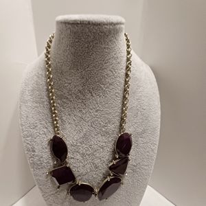 Gold tone, with plum colored large stones.